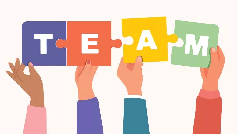 hands holding letters to spell out "team"