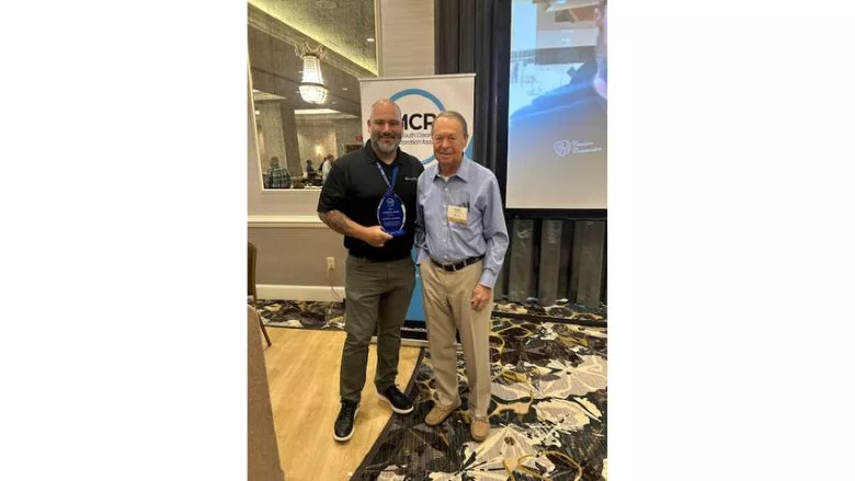 Patrick DaSilva receive his Award at MCRA's 50th Anniversary meeting