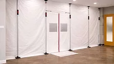 temporary containment barrier constructed with white polyethylene sheeting