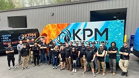 KPM Restoration team standing in front of trailer