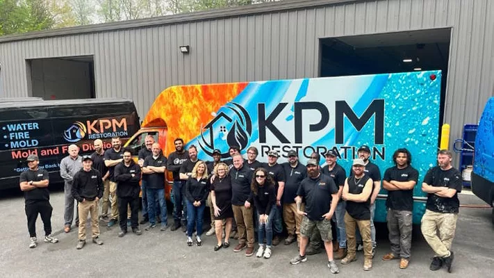 KPM Restoration team KPM Restoration team standing in front of trailer