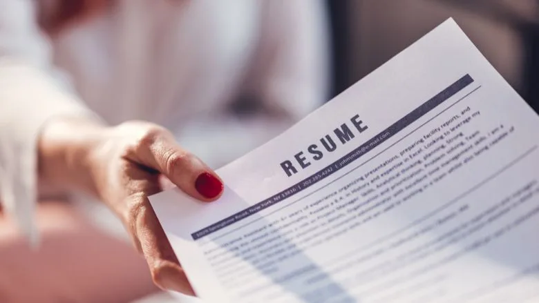 woman giving her resume to a potential employer