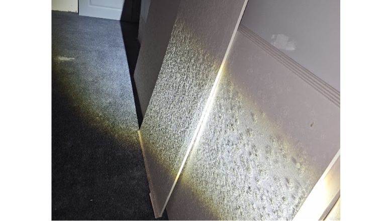 light shining on wall full of mold