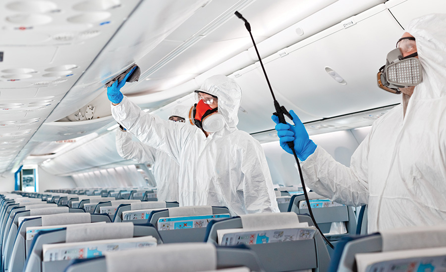 workers disinfecting a plane