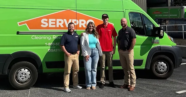 Meredith Truitt with colleagues standing in front of ServPro truck