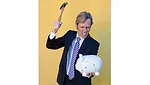 cross stock photo man breaking piggy bank