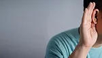 Man holds his hand near ear and listens carefully