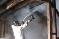 man spraying chemicals remediation