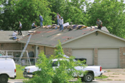 men working on house roof