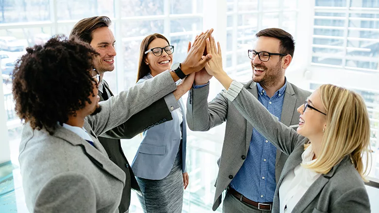 Excited business team gives high-five