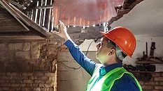 Inspector inside a fire damaged building
