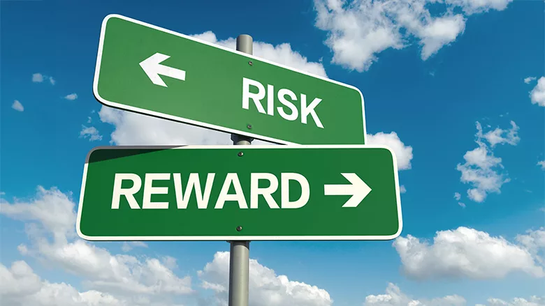 A road sign with "risk" and "reward"