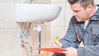 young plumber performing an inspection