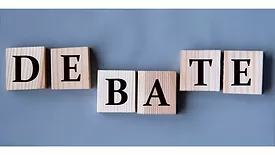 DEBATE spelled out on wooden blocks