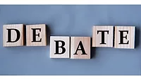 DEBATE spelled out on wooden blocks