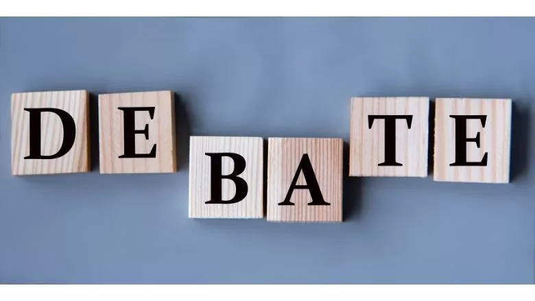 DEBATE spelled out on wooden blocks
