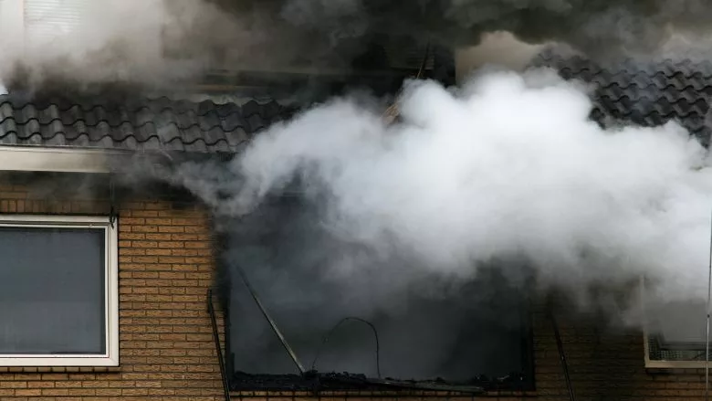 a house consumed in smoke and fire