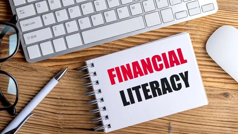 Financial Literacy text on spiral notepad on desk