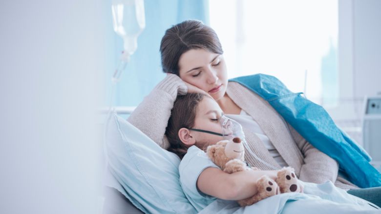 Mother taking care of sick daughter with oxygen mask and teddy bear