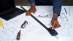 construction worker using smartphone over architectural plans