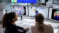 Analyzing Weather Patterns on Computer with Forecast Map for Tracking