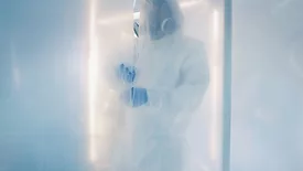 Scientist in clean coat checking biohazardous substance