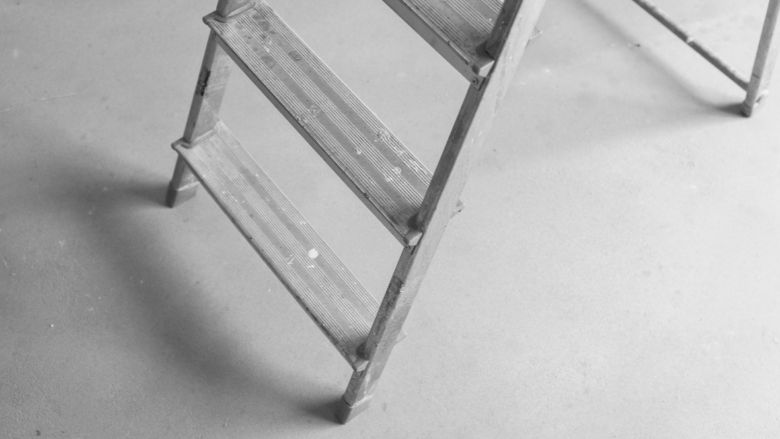 Gray ladder on a white background