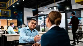 Recruiter and candidate greeting each other during a job interview