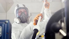 worker wearing respirator and PPE worker wearing respirator and PPE