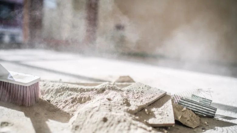 Worker cleaning construction site during home renovation