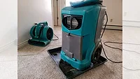 Air mover and a dehumidifier drying out the flooring and walls in a home Air mover and a dehumidifier drying out the flooring and walls in a home