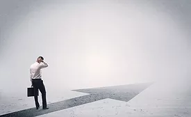A professional businessman thinking while standing on a black arrow pointing forward